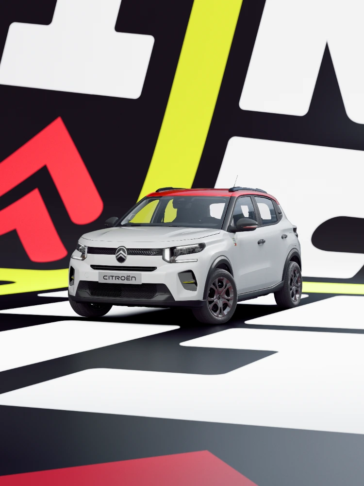 Vista tres cuartos delantera del Citroën ë-C3 TONIC edición limitada, coche eléctrico urbano con postura dinámica y ambiente gráfico, alternativa electrica inteligente